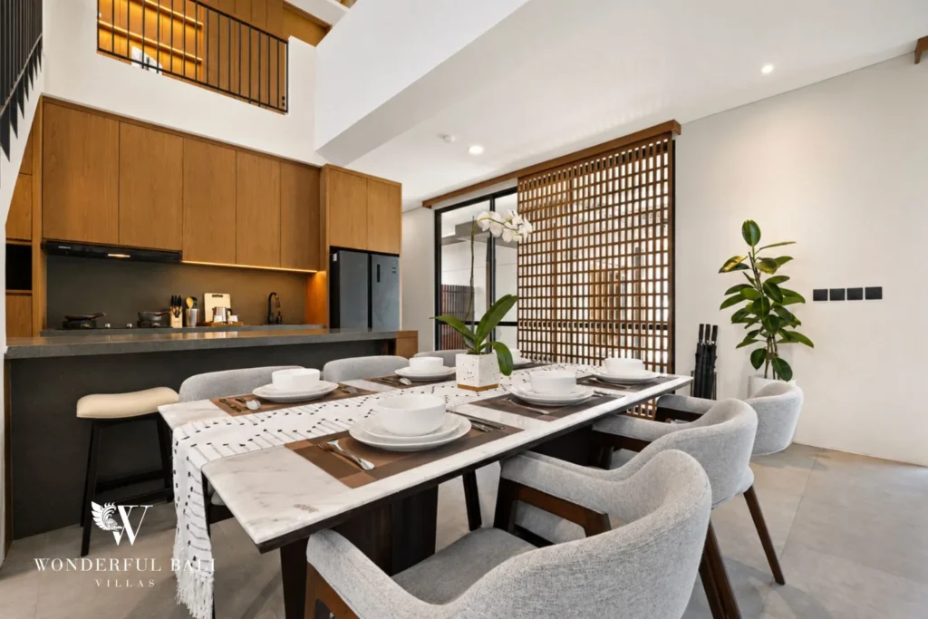 Marble dining table for eight beside the oak kitchen in a 3-bedroom villa in Jimbaran Bali