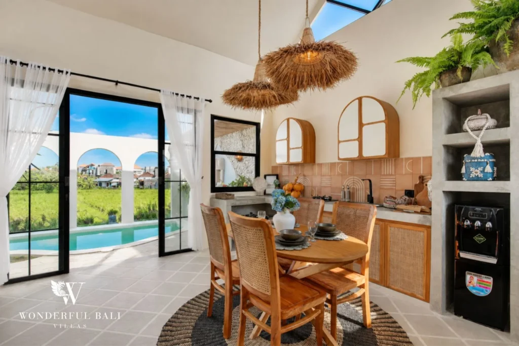 Kitchen and dining area with terracotta tiles and rattan pendants in a 2-bedroom villa in Buduk Canggu Bali