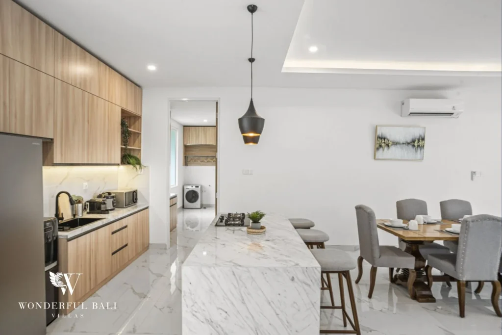 Kitchen with Calacatta marble island and pale timber cabinetry in a 3-bedroom villa in Kaba-Kaba Bali