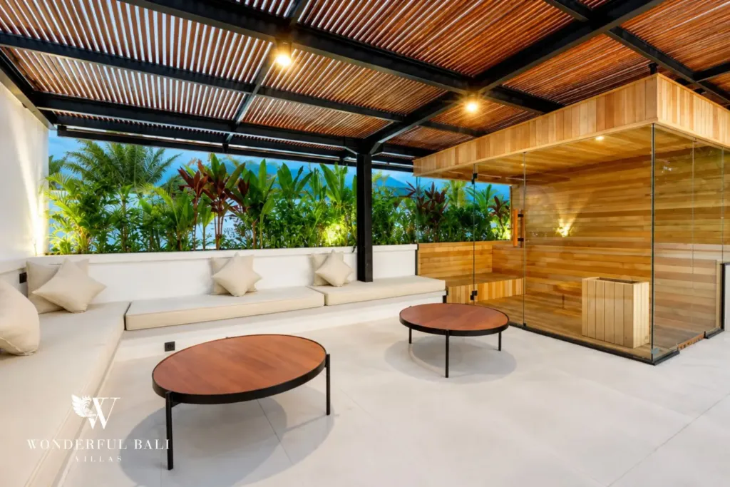 Rooftop lounge seating beside a glass-fronted cedar sauna at a 3BR villa in Pererenan Bali