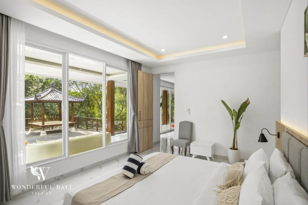Bedroom with full-height glass onto the pool deck in a 3-bedroom villa in Kaba-Kaba Bali