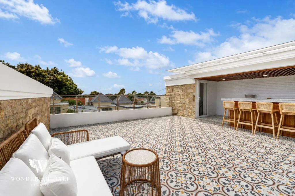 Rooftop terrace with encaustic tiles and teak bar at a 3-bedroom villa in Tumbak Bayuh Bali