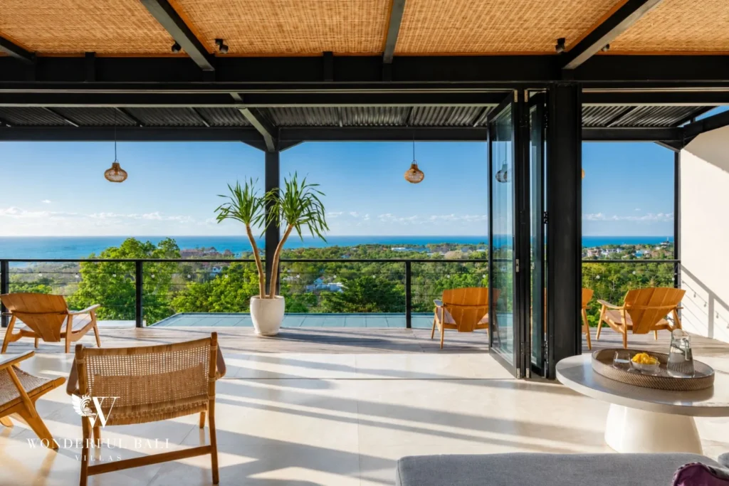 Covered upper terrace looking over treetops to the ocean at a 5-bedroom villa in Uluwatu Bali