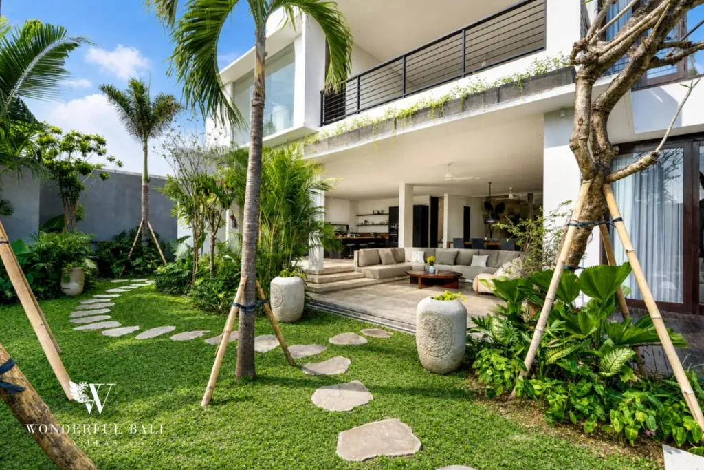 4BR villa for rent in Seminyak — garden, lawn and stepping stones leading to the living pavilion