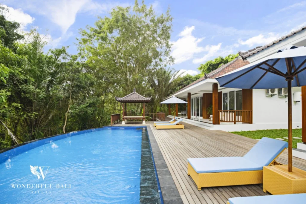 Infinity pool and timber deck beside the villa at a 3-bedroom villa in Kaba-Kaba Bali