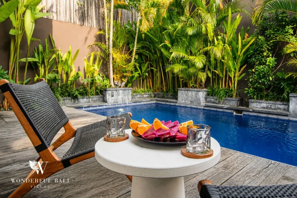 2BR villa for rent in Bumbak, Umalas — pool, rope lounge chairs and a fruit platter on the pool deck at a 2-bedroom villa