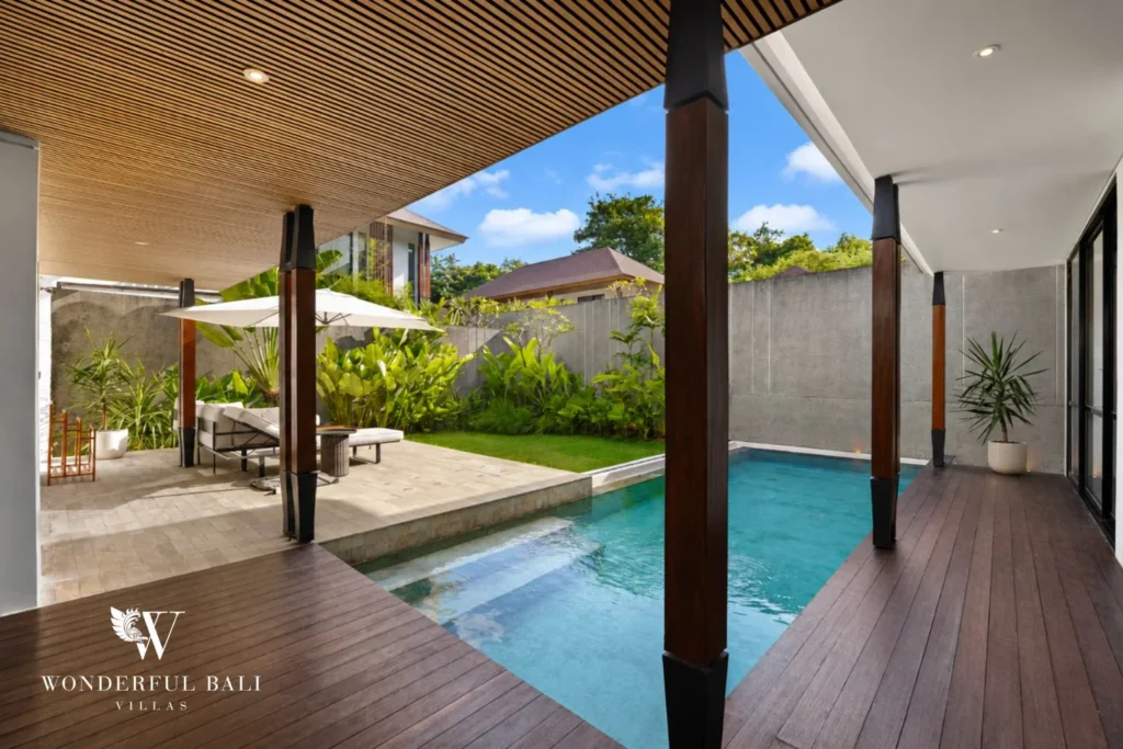 Covered timber terrace looking over the pool at a 3-bedroom villa in Jimbaran Bali