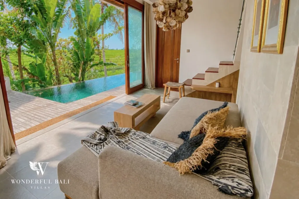 3BR villa for rent in Kedungu — living room, sofa facing the pool and the rice paddy