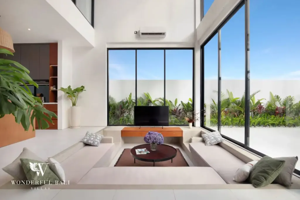 Sunken living room with smart TV and garden glazing at a 3BR villa in Pererenan Bali