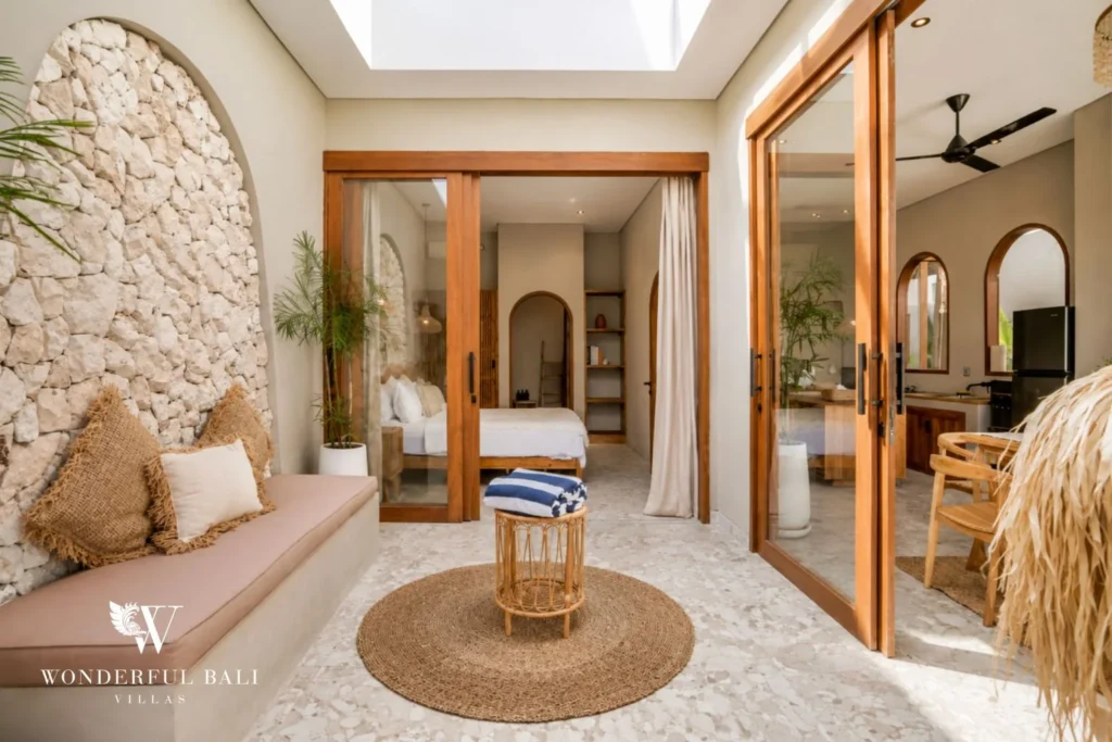 Stone-walled courtyard with a built-in bench opening to a bedroom at a 2-bedroom villa in Pererenan Bali