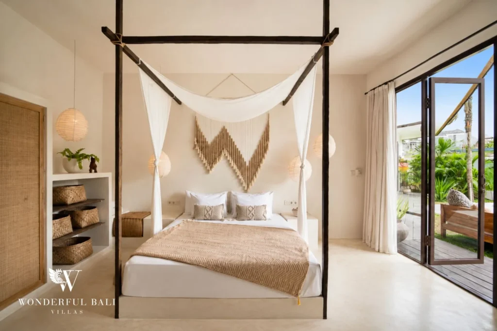 Bedroom with a four-poster bed and macrame hanging opening to the garden in Umalas Bali