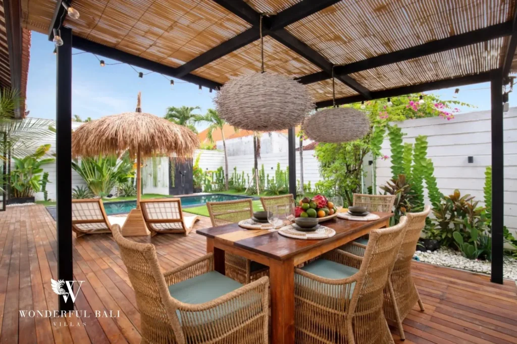 Teak dining table for eight under a bamboo pergola at a 3-bedroom villa in Umalas Bali