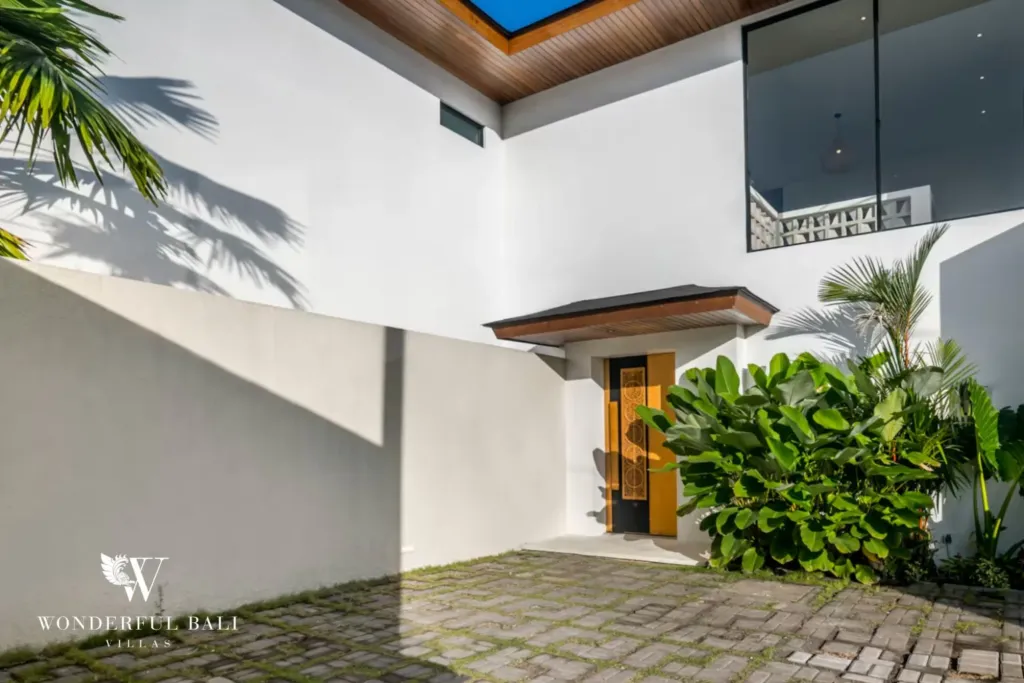 4BR villa for rent in Pererenan — entrance, carved timber door off a paved courtyard