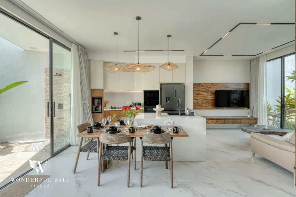Open-plan living and dining with rattan pendants and sliding glass in a 3-bedroom villa near Nusa Dua Bali