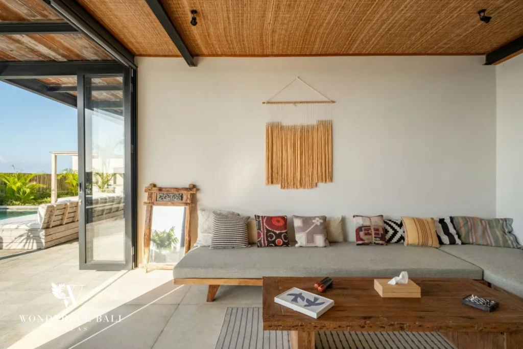 Long banquette seating under a rattan ceiling in a 5-bedroom villa in Uluwatu Bali
