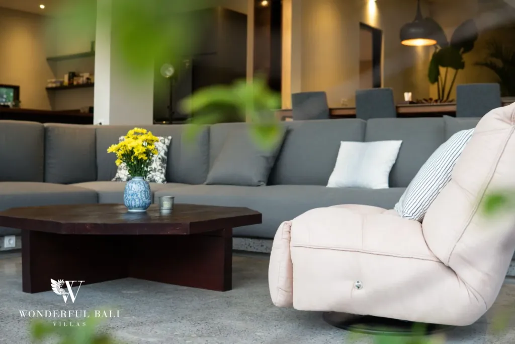 4BR villa for rent in Seminyak — living room, sectional sofa and armchair around a timber table