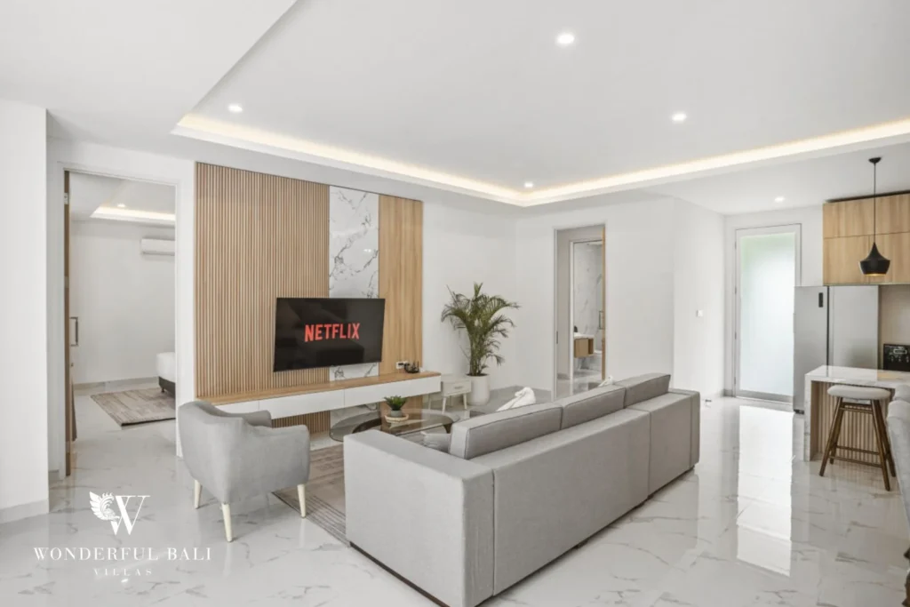 Living room with fluted timber media wall and smart TV in a 3-bedroom villa in Kaba-Kaba Bali