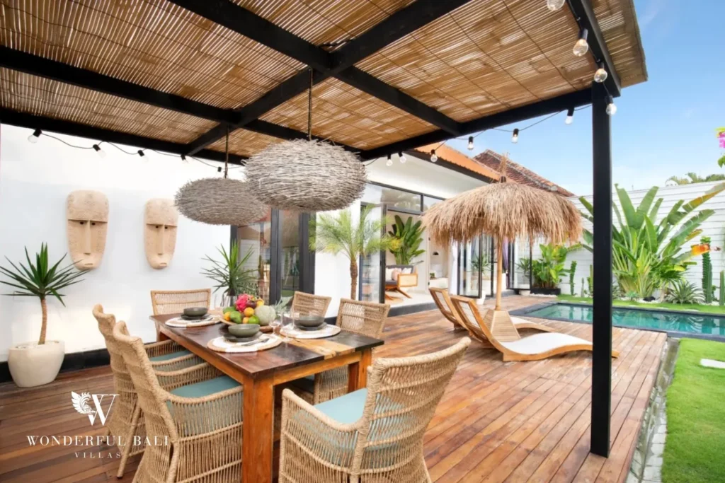 Outdoor dining under woven nest lights beside the pool at a 3-bedroom villa in Umalas Bali