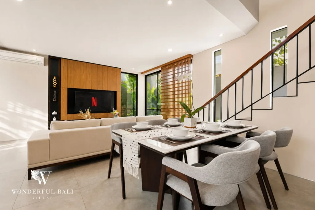 Open-plan living and dining under a double-height ceiling in a 3-bedroom villa in Jimbaran Bali