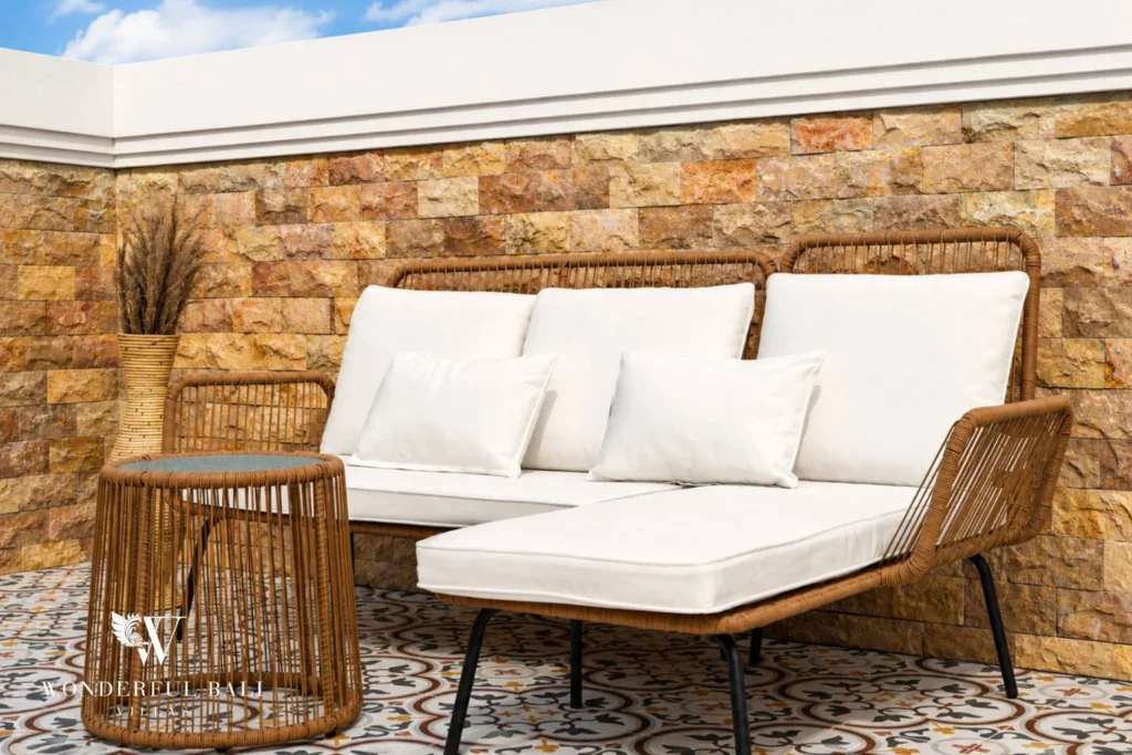 Rattan lounge seating against a stone wall on the rooftop of a 3-bedroom villa in Tumbak Bayuh Bali