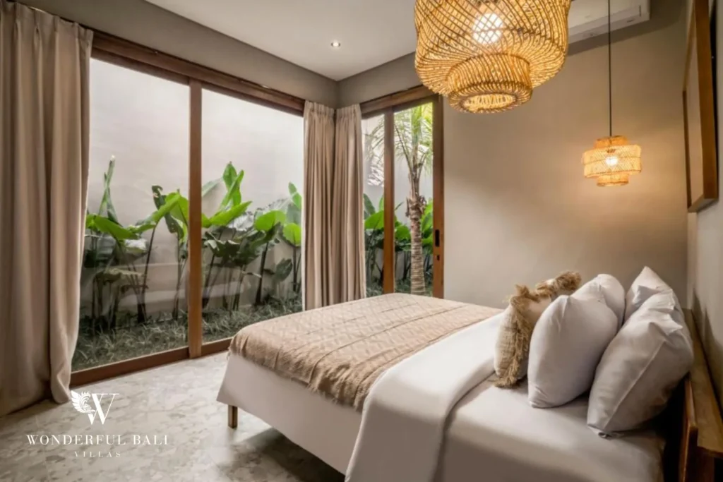 Bedroom with sliding glass onto a planted garden in a 2-bedroom villa in Pererenan Bali