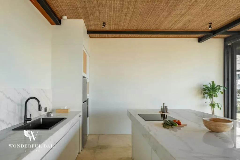 Marble kitchen run with black tapware in a 5-bedroom villa in Uluwatu Bali
