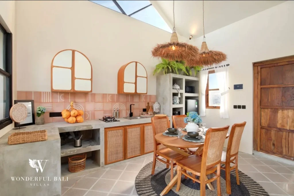 Concrete kitchen with rattan cabinet fronts and terracotta tiled splashback in a 2-bedroom villa in Buduk Canggu Bali