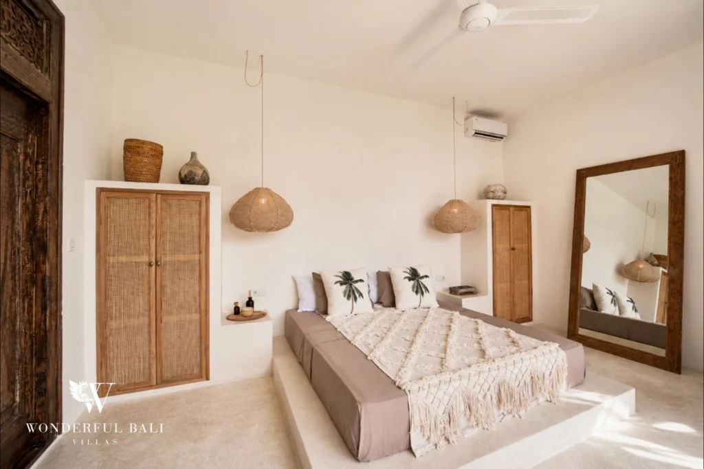 Bedroom with a timber wardrobe and full-length mirror in a 3-bedroom villa in Umalas Bali