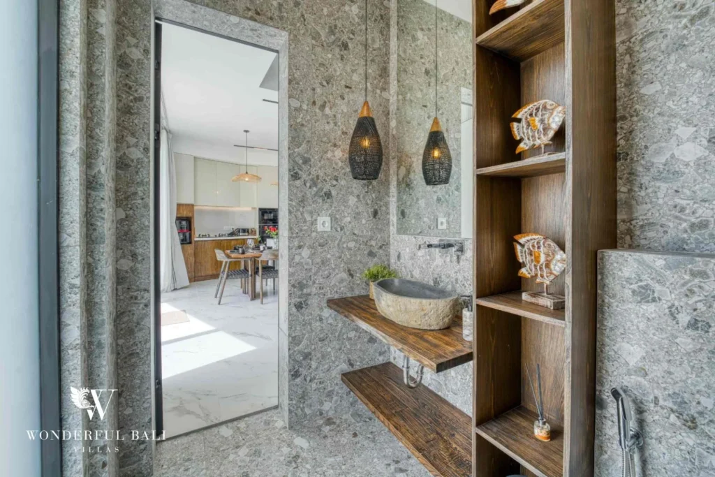 Guest bathroom with terrazzo walls and a carved stone basin in a 3-bedroom villa near Nusa Dua Bali