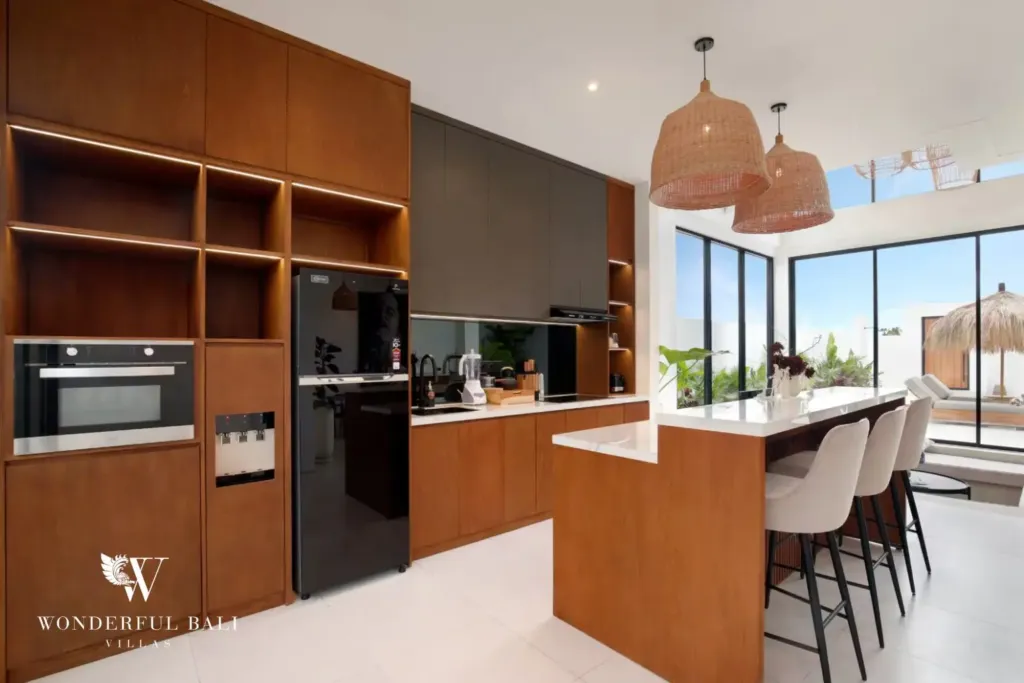 Fitted kitchen with oven, hob and large fridge at a 3BR villa in Pererenan Bali