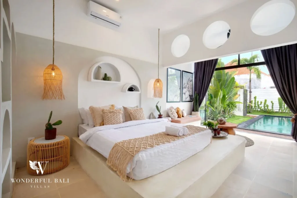 Main bedroom with plaster platform bed and round clerestory portholes in a 3-bedroom villa in Umalas Bali