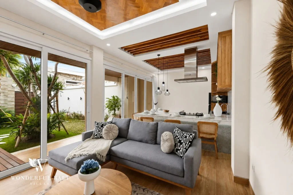 Open-plan living and kitchen under exposed teak beams in a 3-bedroom villa in Tumbak Bayuh Bali