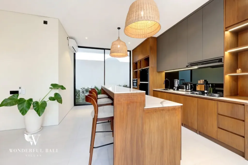 Galley kitchen with stone breakfast bar at a 3BR villa in Pererenan Bali