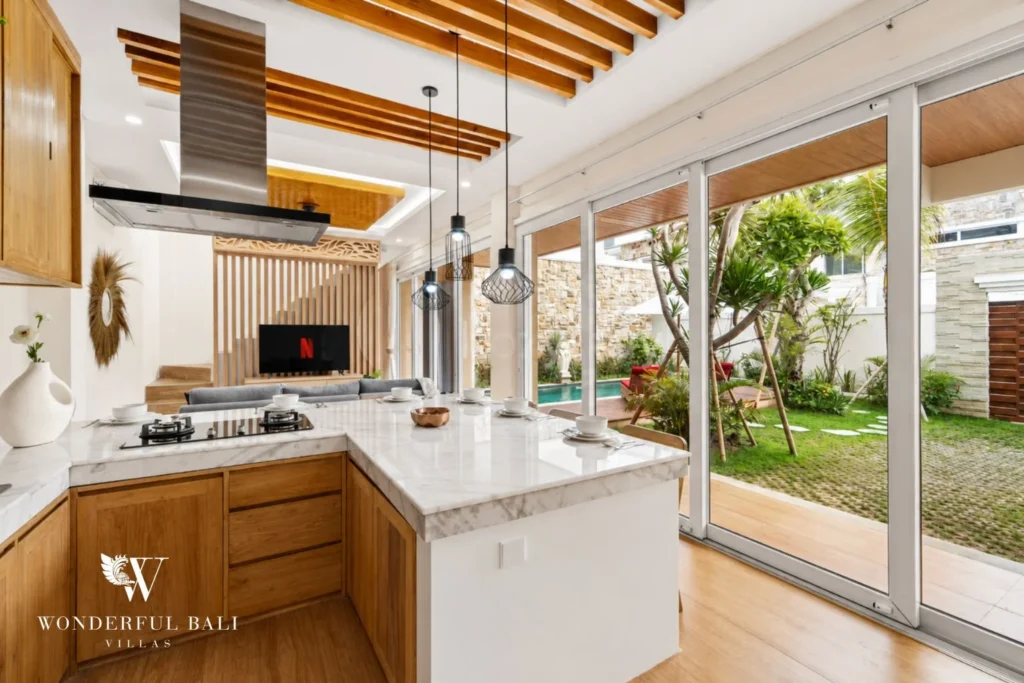 Kitchen with marble splashback and teak cabinetry in a 3-bedroom villa in Tumbak Bayuh Bali