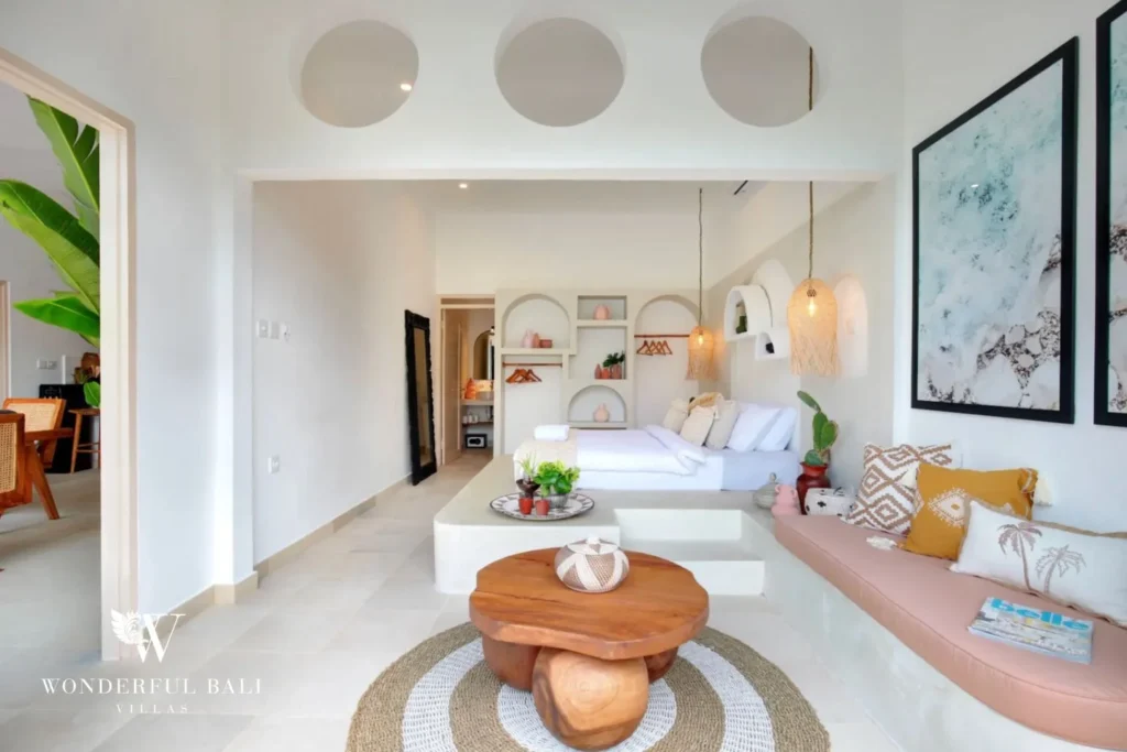 Main bedroom with built-in banquette and arched display niches in a 3-bedroom villa in Umalas Bali