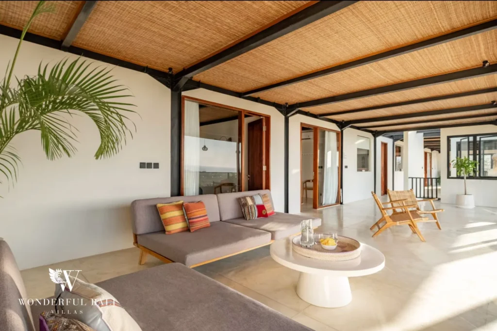 Upper lounge seating and rattan chairs under a rattan ceiling in a 5-bedroom villa in Uluwatu Bali
