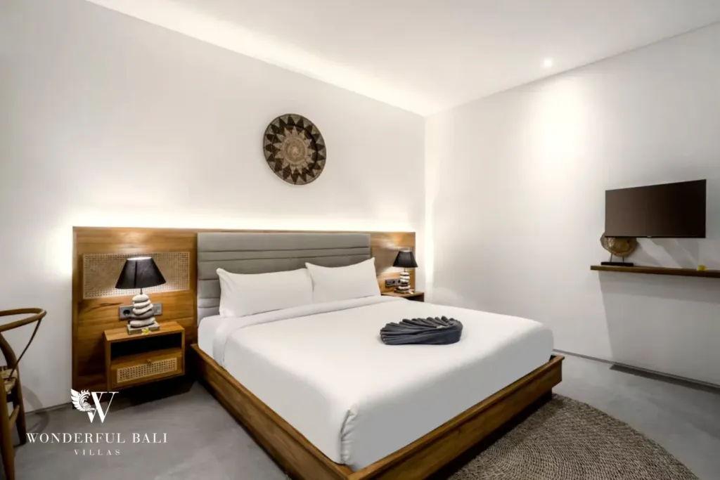 4BR villa for rent in Pererenan — bedroom, king bed with cane bedside panels and a smart TV