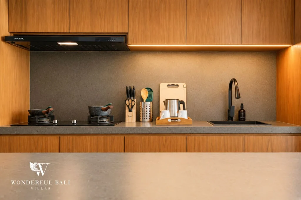Kitchen hob and sink along a stone worktop in a 3-bedroom villa in Jimbaran Bali