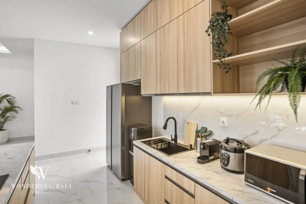 Full kitchen run with double-door fridge and marble counters in a 3-bedroom villa in Kaba-Kaba Bali