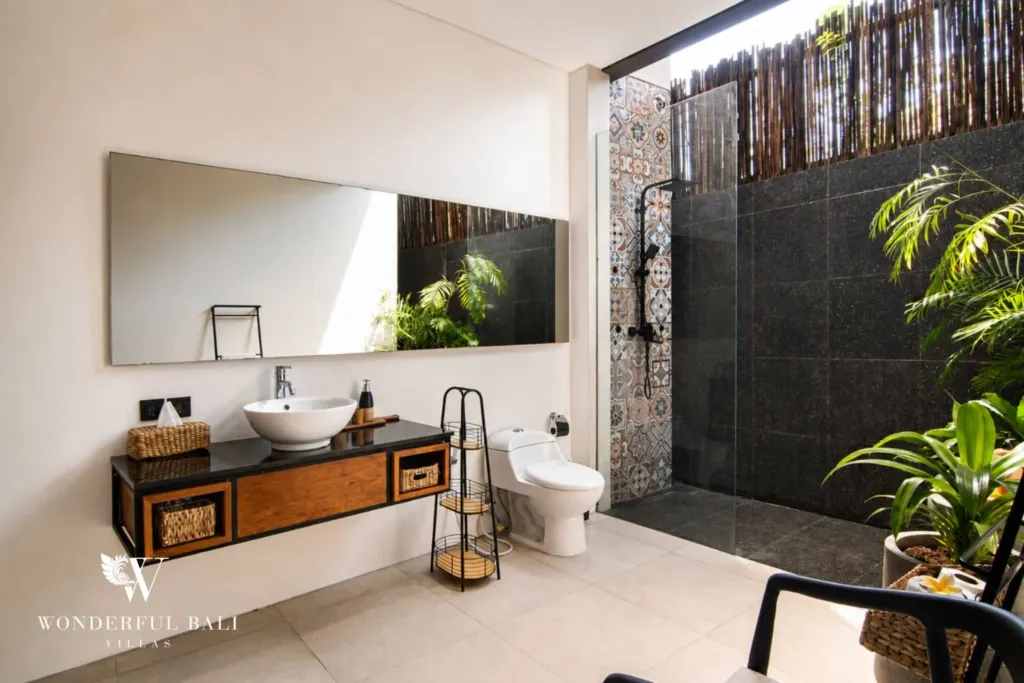 2BR villa for rent in Bumbak, Umalas — bathroom, a floating timber vanity and a semi-open black stone shower with patterned tile