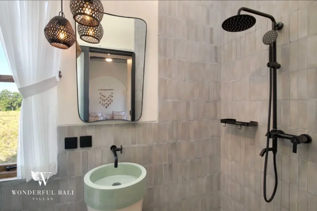 Bathroom in zellige tile with moulded terrazzo basin and rain shower in a 2-bedroom villa in Buduk Canggu Bali