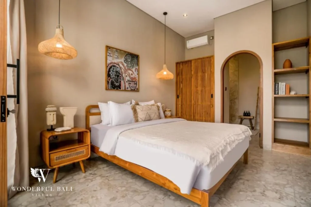 Bedroom with slatted teak wardrobe and open shelving in a 2-bedroom villa in Pererenan Bali