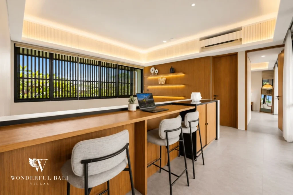 Upstairs home office with a long oak desk and three stools in a 3-bedroom villa in Jimbaran Bali
