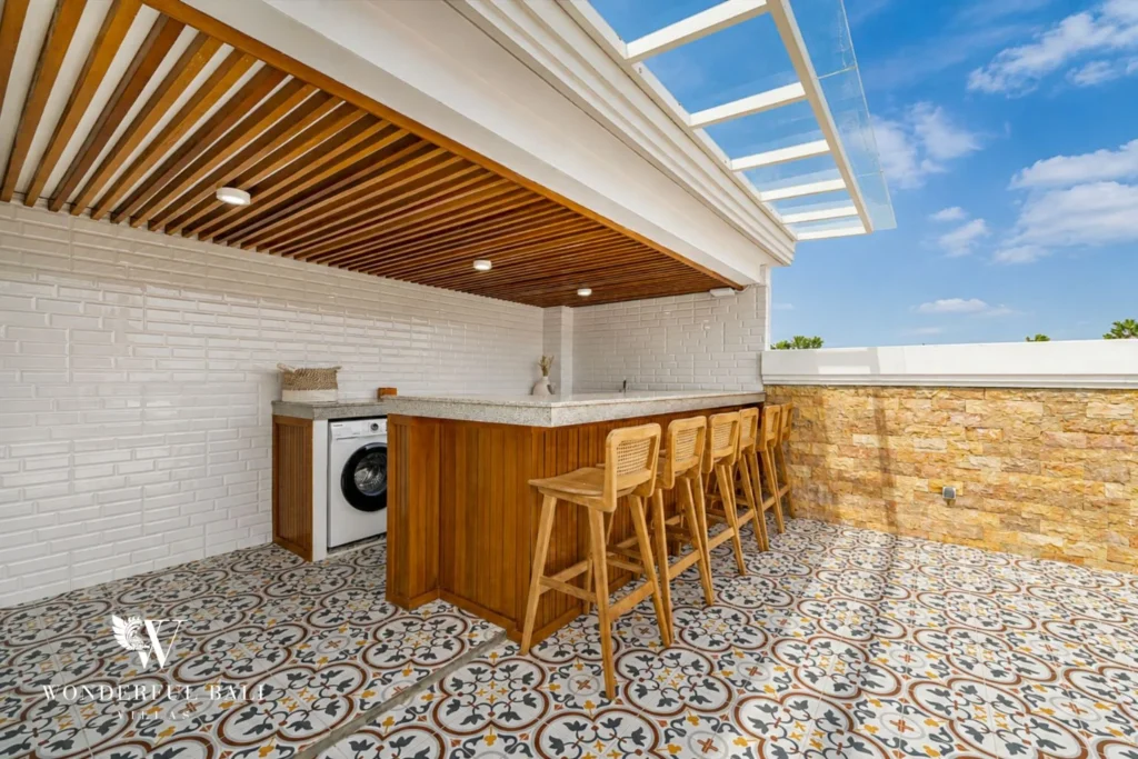 Rooftop bar counter under a slatted pergola at a 3-bedroom villa in Tumbak Bayuh Bali