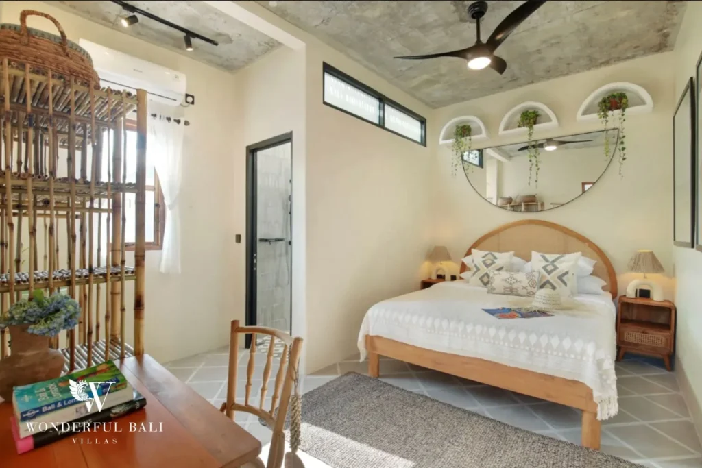 Second bedroom with arched rattan headboard and wall niches in a 2-bedroom villa in Buduk Canggu Bali