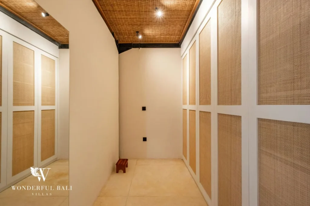 Walk-in closet with rattan-panelled doors in a 5-bedroom villa in Uluwatu Bali