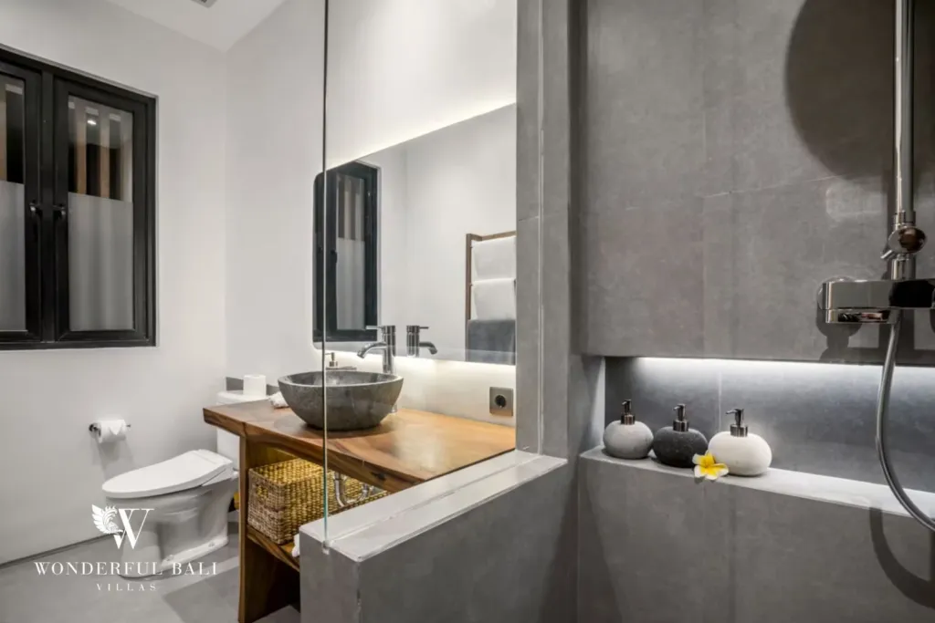 4BR villa for rent in Pererenan — bathroom, stone basin on a timber vanity with a glass shower screen
