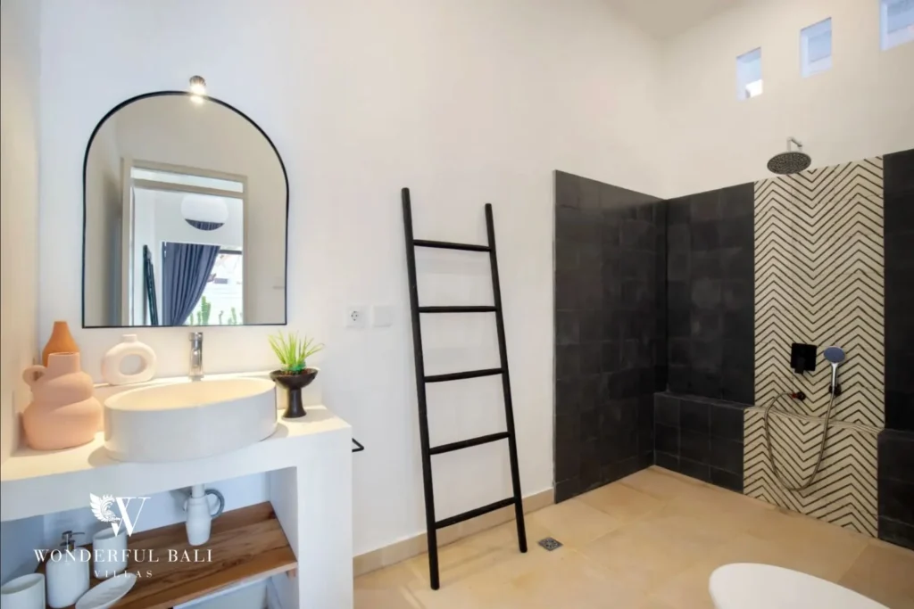 Bathroom with black and chevron tiled walk-in shower in a 3-bedroom villa in Umalas Bali