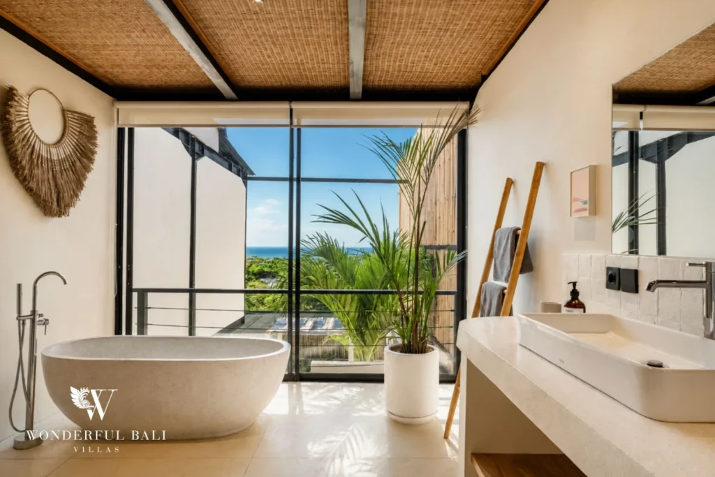 Freestanding terrazzo tub at a window onto the sea in a 5-bedroom villa in Uluwatu Bali
