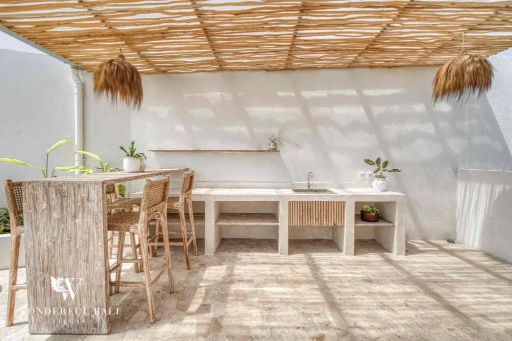 Rooftop stone kitchen counter with bar stools under a pergola near Nusa Dua Bali